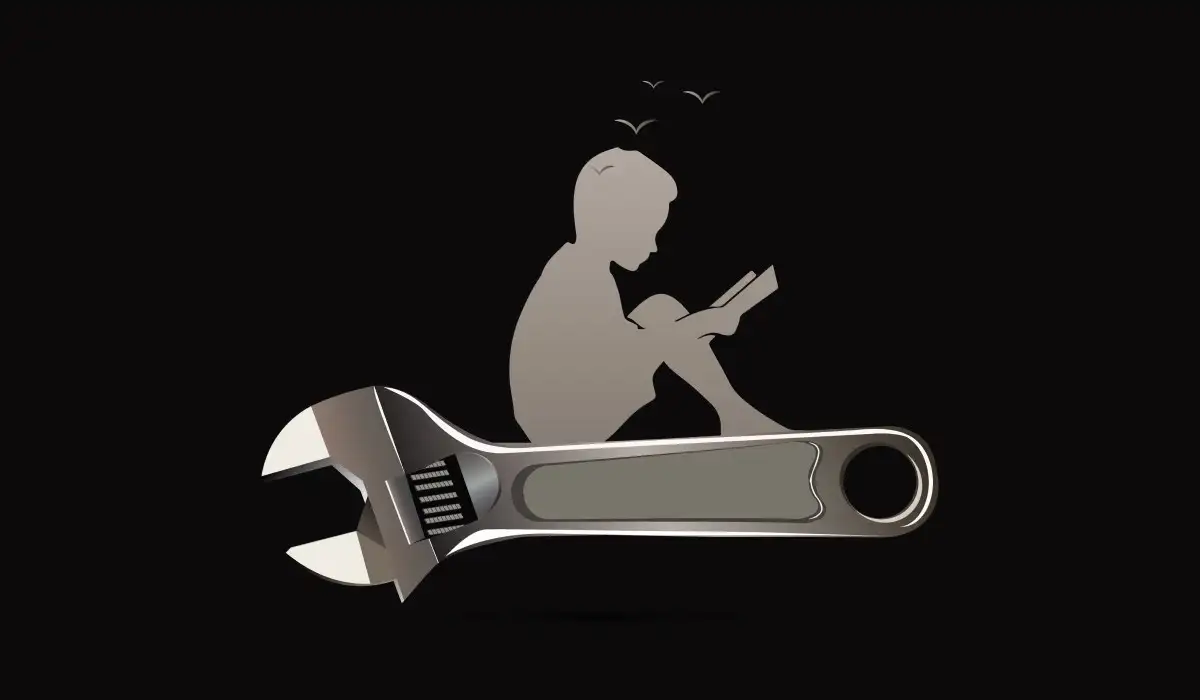 Silhouette of a child reading and sitting on a wrench