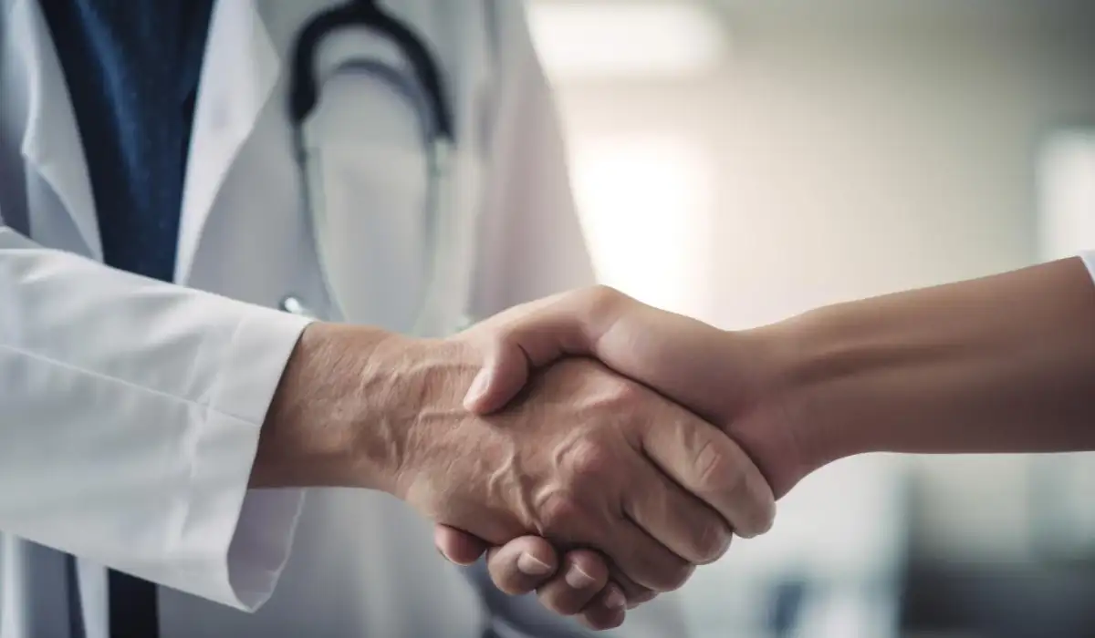 Doctor and patient shaking hands in a hospital
