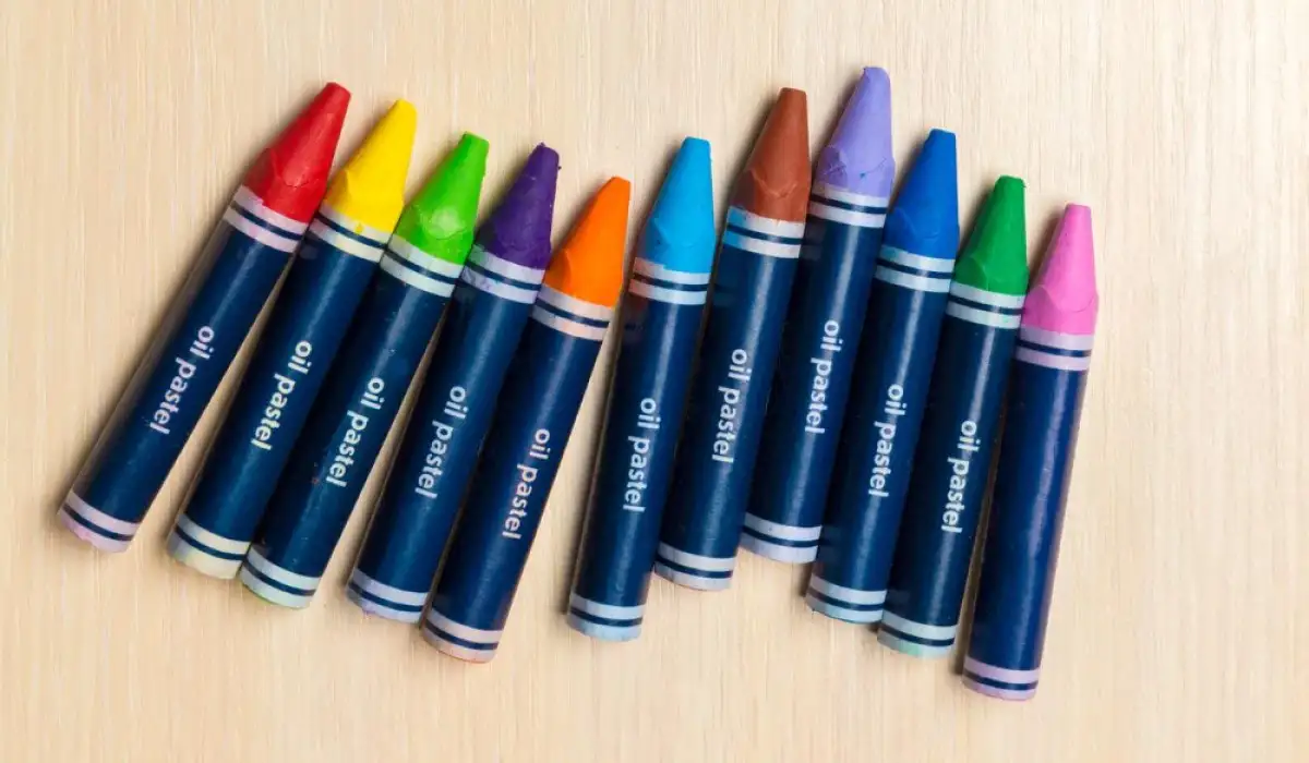 Various crayons on wooden background