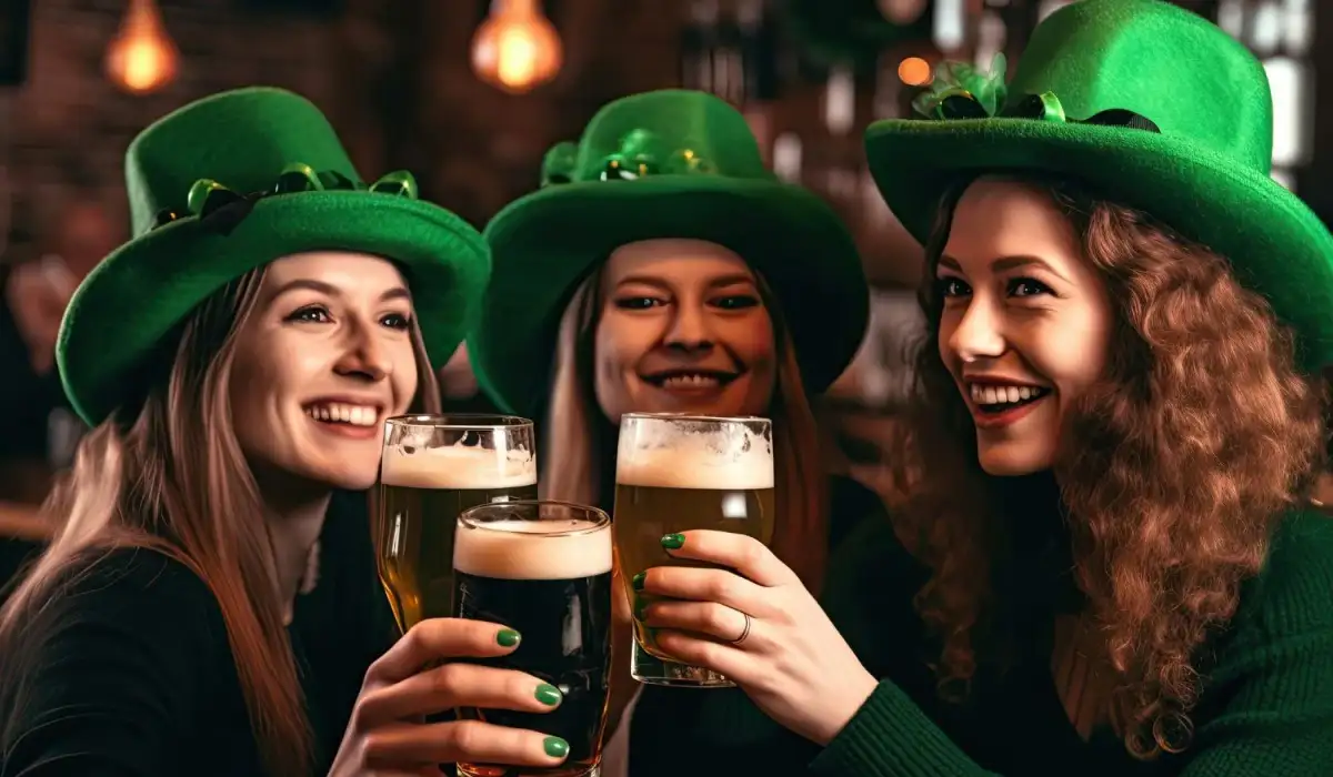 Three women celebrating Saint Patrick's Day with beers and wearing green hats