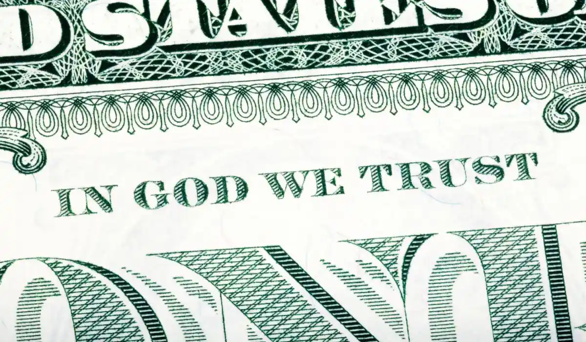 In God we trust phrase visible fragment of a dollar