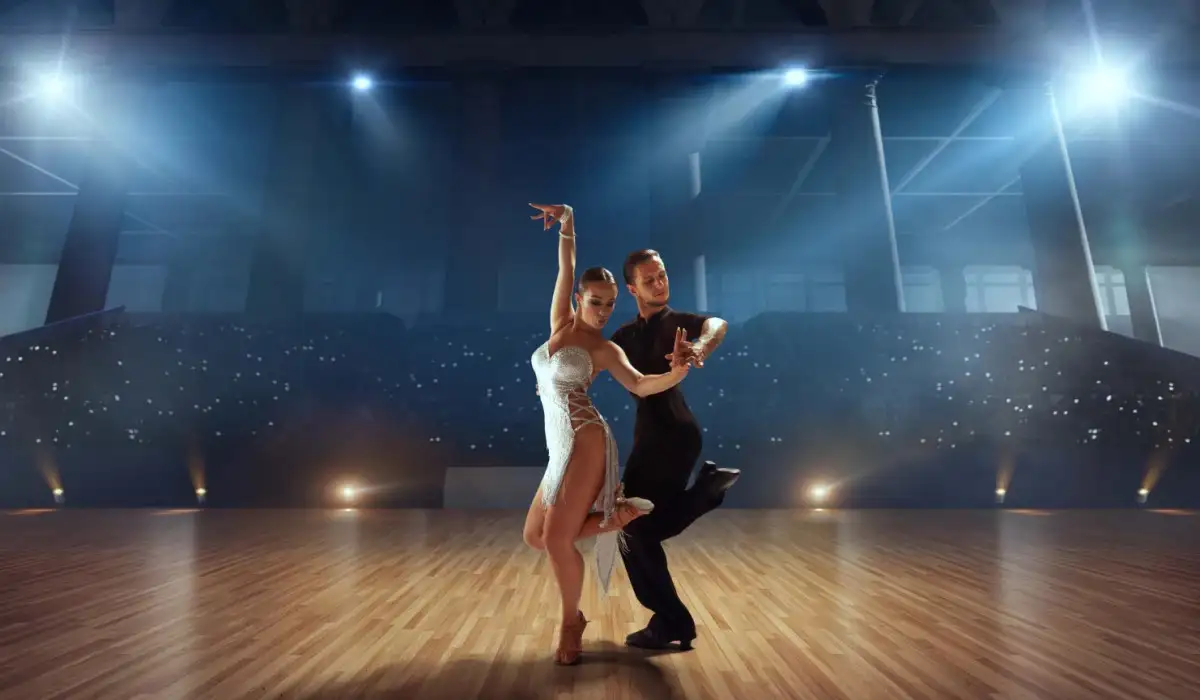 Couple of dancers perform Latin dances in a large professional hall