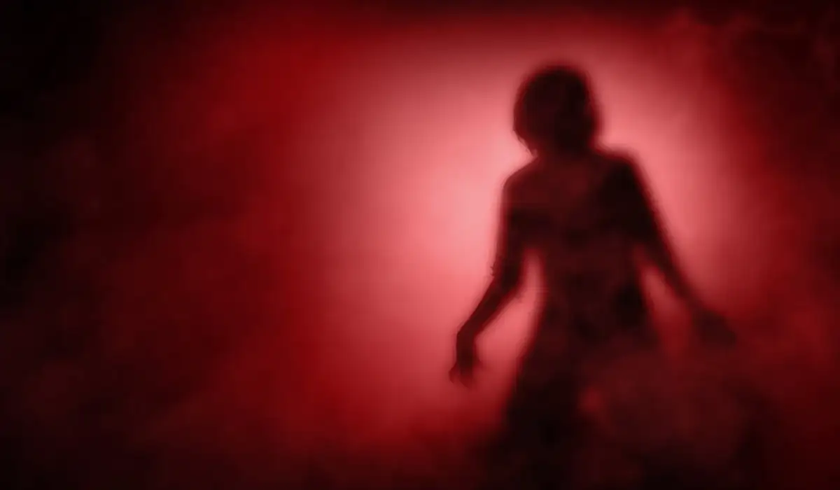 Silhouette of a scary woman with a dramatic background
