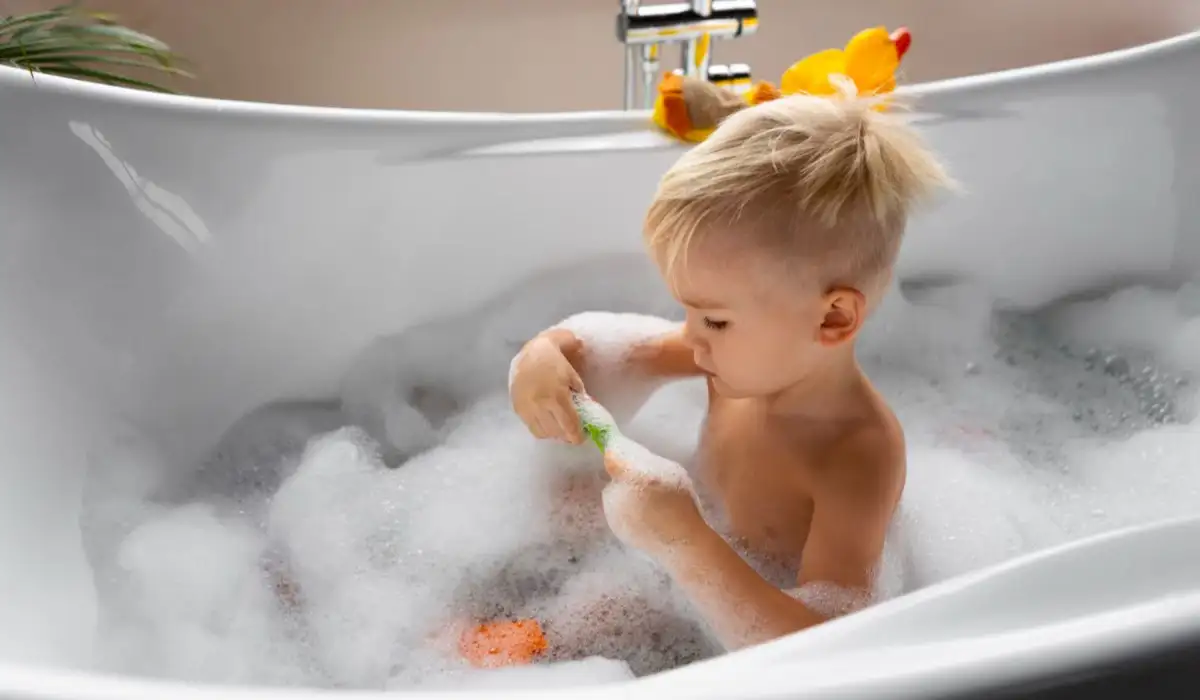 Boy playing in the bathtub during a bubble bath