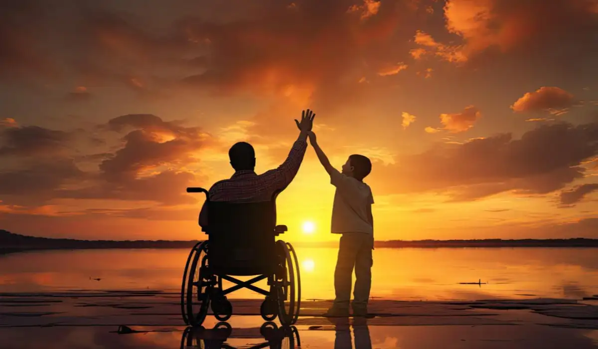 A young man in a wheelchair raises his hand with a child on his side together at sunset