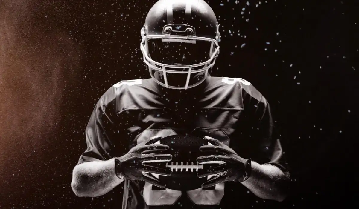 American football player with ball in hand in a composite image of dust splashes