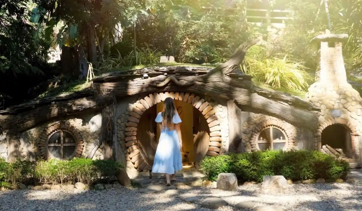 Back view of a young beautiful woman going to the little hobbits house
