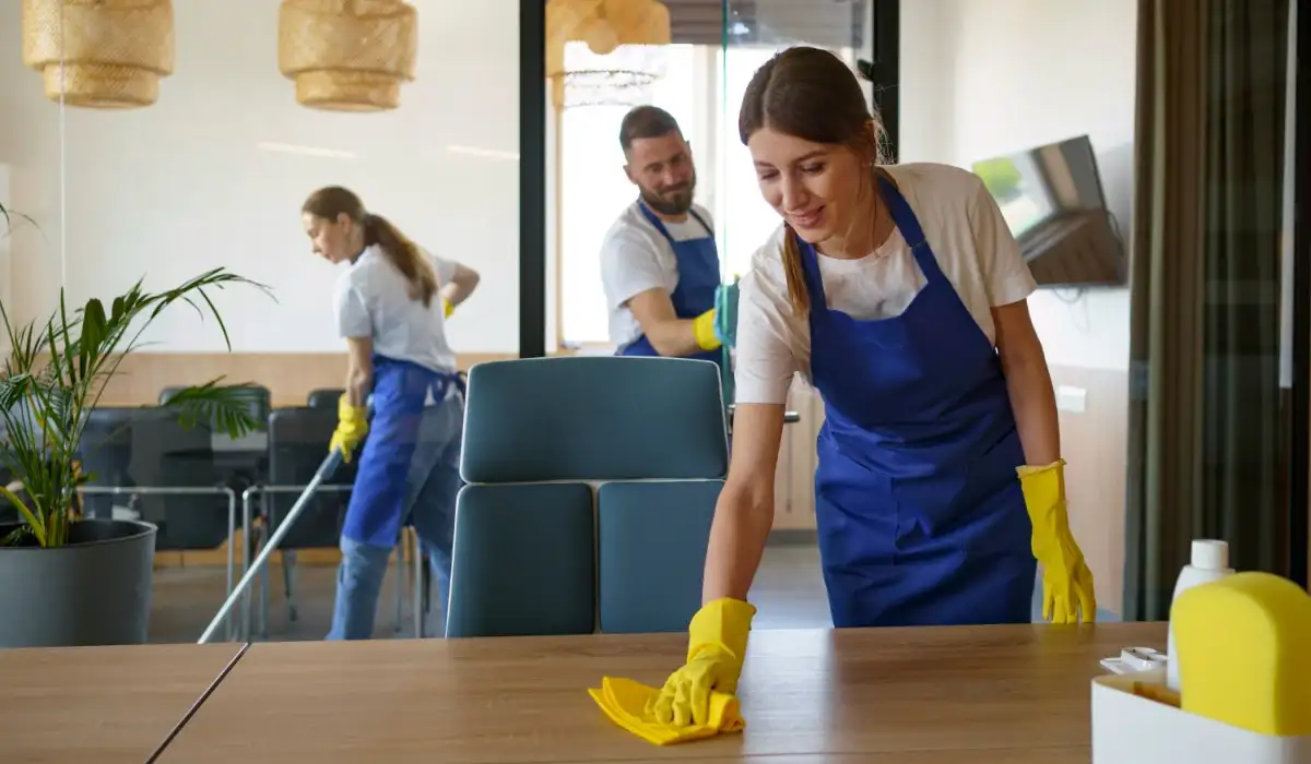 Professional cleaning service people working together in an office
