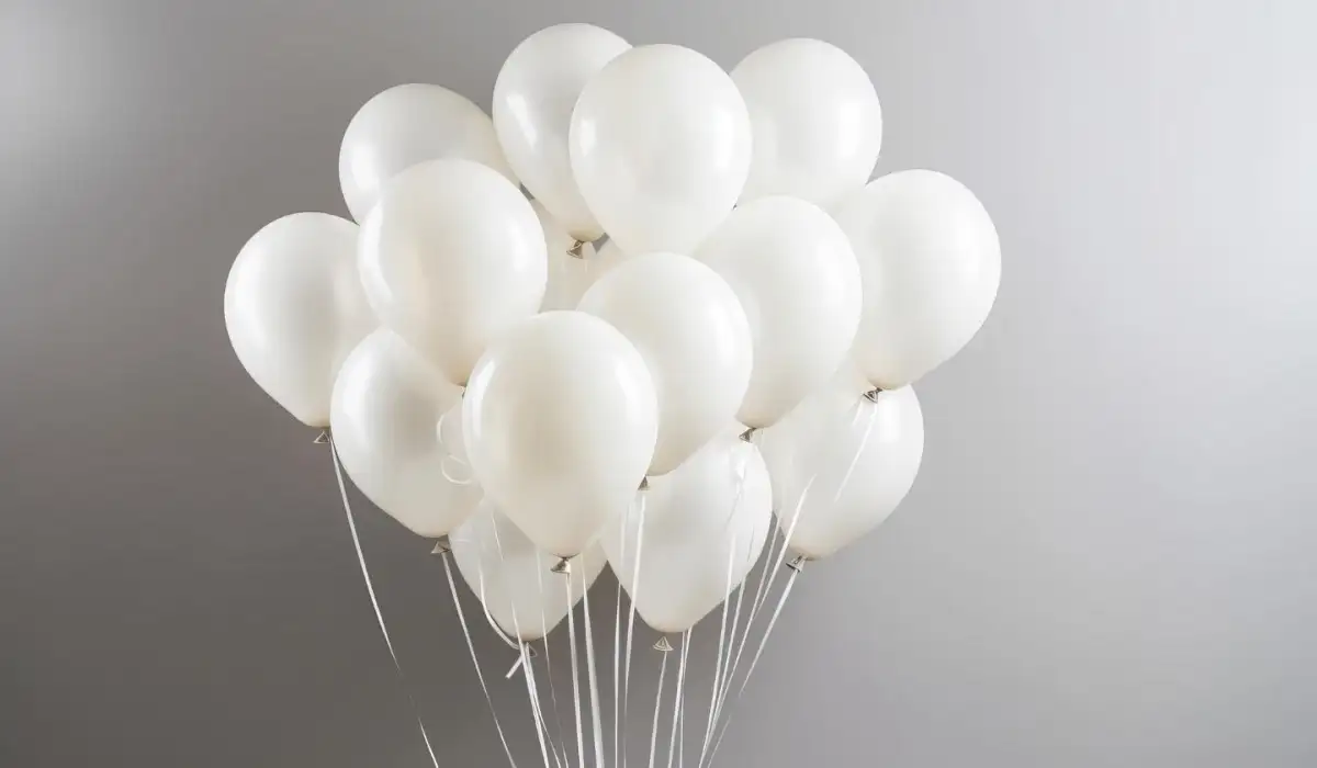 Bunch of white balloons on gray wall background