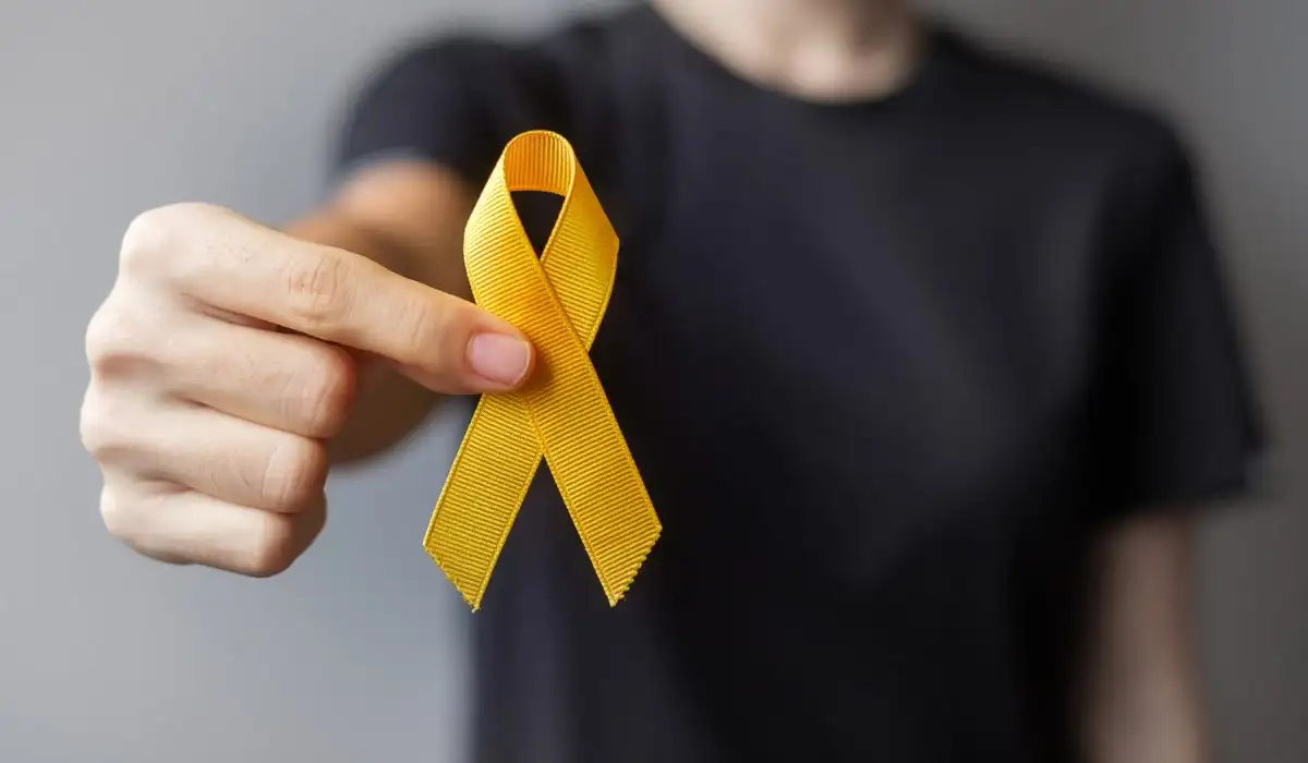 Man holding a golden ribbon for suicide prevention