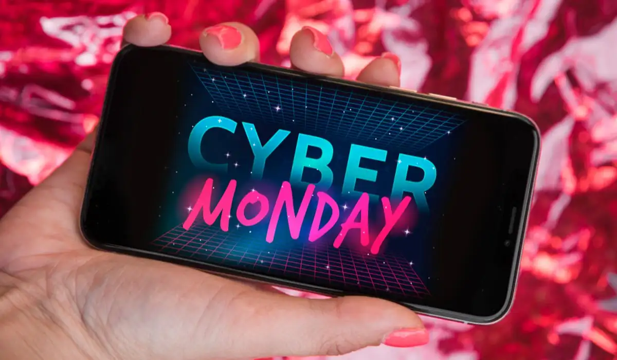 Woman holding a smartphone with Cyber Monday inscription