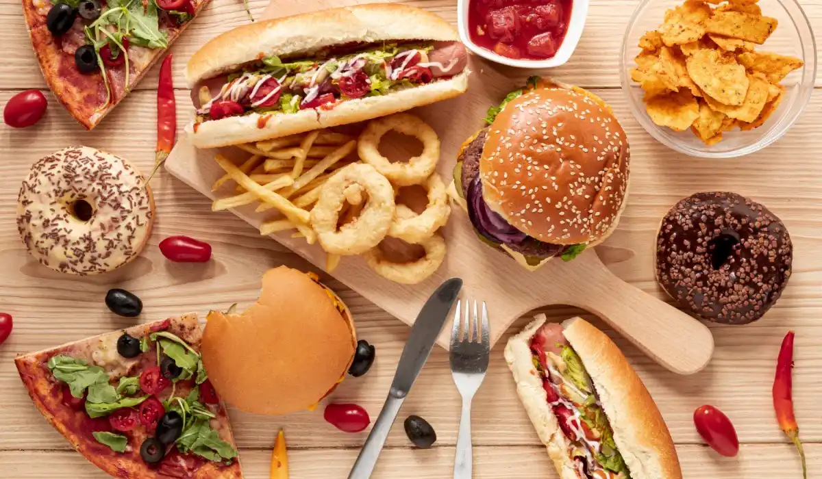Arrangement with fast food on wooden background