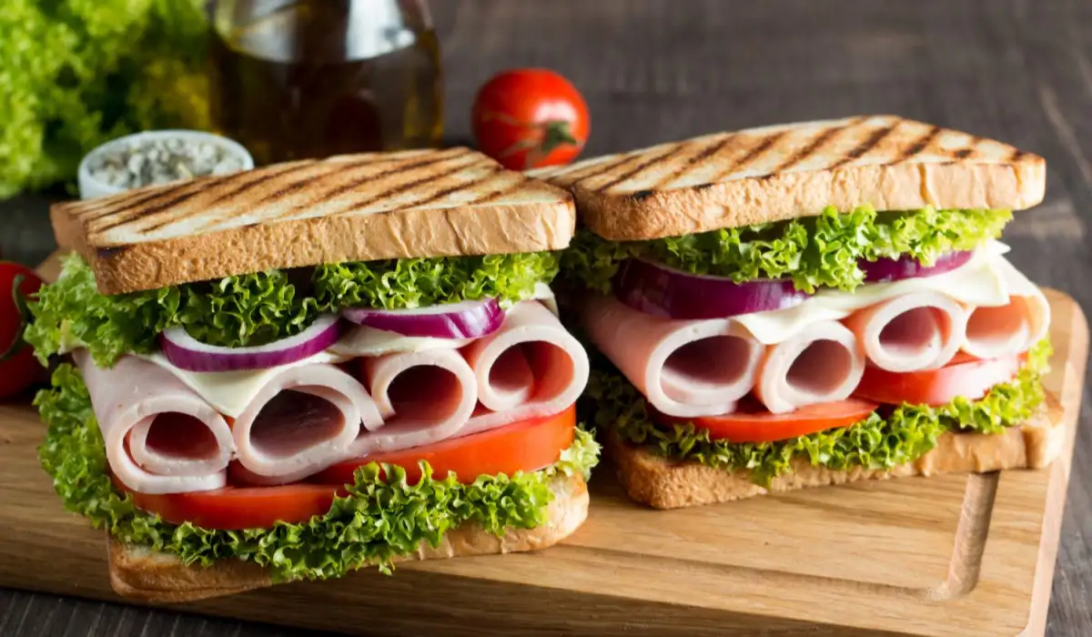 A club sandwich with meat, salad and vegetables