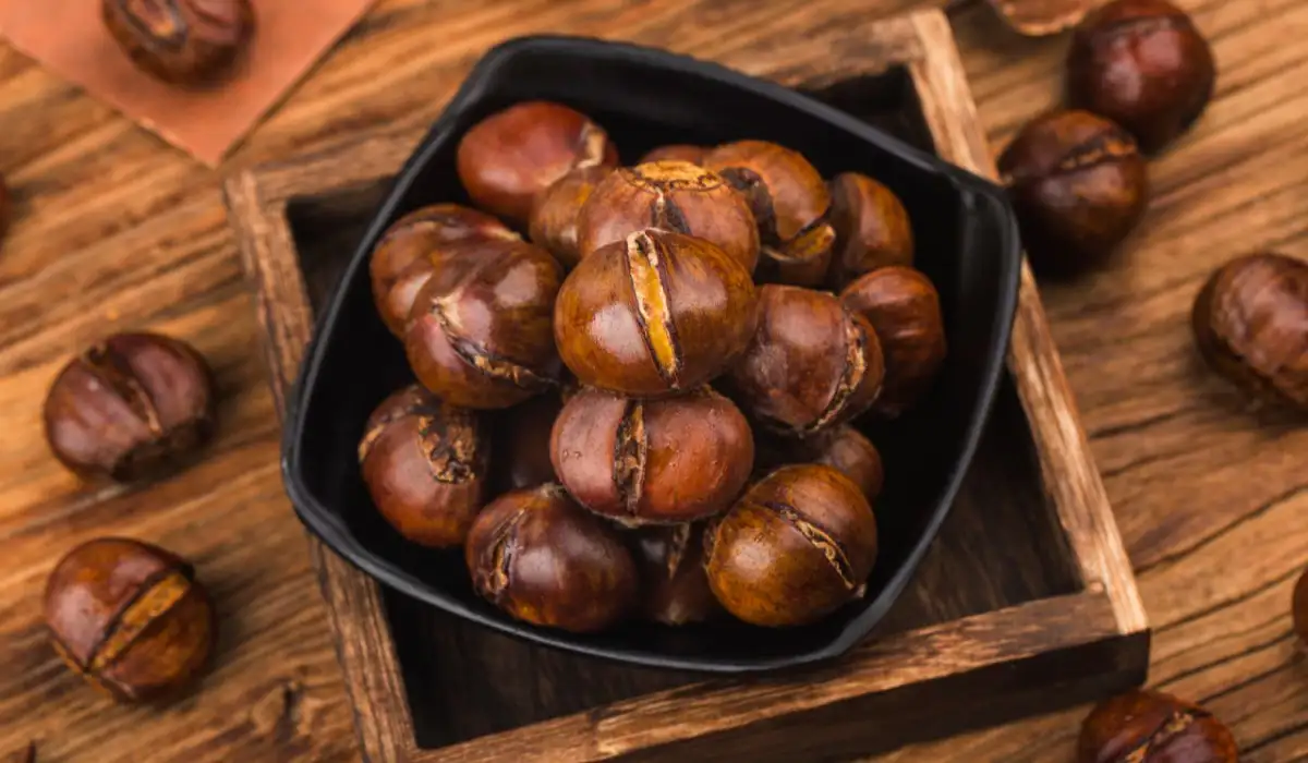 Chestnuts on a wooden background